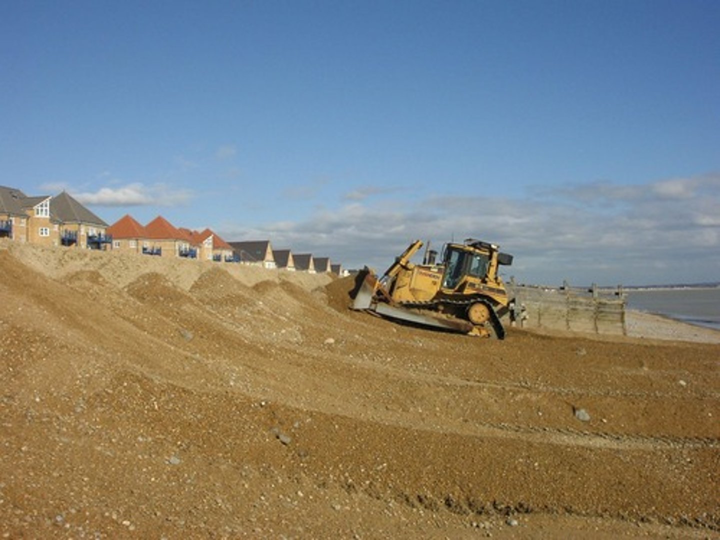 <p>It was at a huge risk of permanent flooding due to climate change. A shingle ridge was the only protection so in 1990 the council started a programme of beach reprofiling, costing an unsustainable £200,000 a year. there was a cause for concern over 348 homes, roads, water treatment plant, holiday homes. In 2008, the last flood cost £5 million in damage.</p>