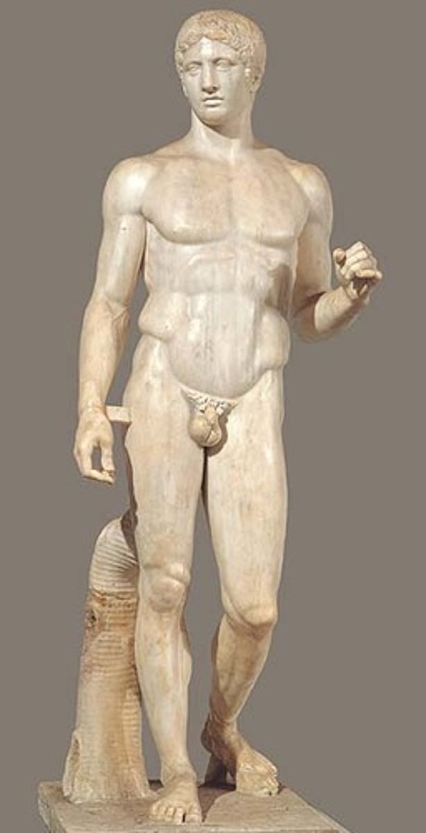 <p>Form:<br>-marble (Roman); bronze (Greek)<br>-contrapposto: shifted weight<br>-not meant to portray a specific person but rather specific characteristics of a Greek<br>Function:<br>-portray the physical perfection of a human figure<br>Content:<br>-everyone is imperfect but brings together different body proportions to make physical<br>-missing its spear<br>-athlete and warrior<br>-gazes off in the distance<br>Context:<br>-Artist= Polykleitos of Argos in 450 BCE <br>-Roman copy of the Greek original</p>