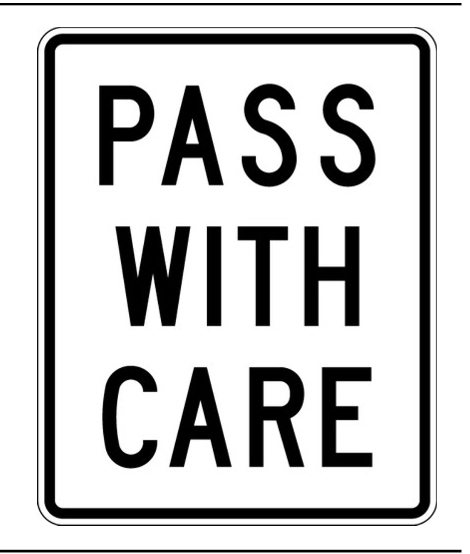 <p>What does a Pass With Care sign instruct?</p>
