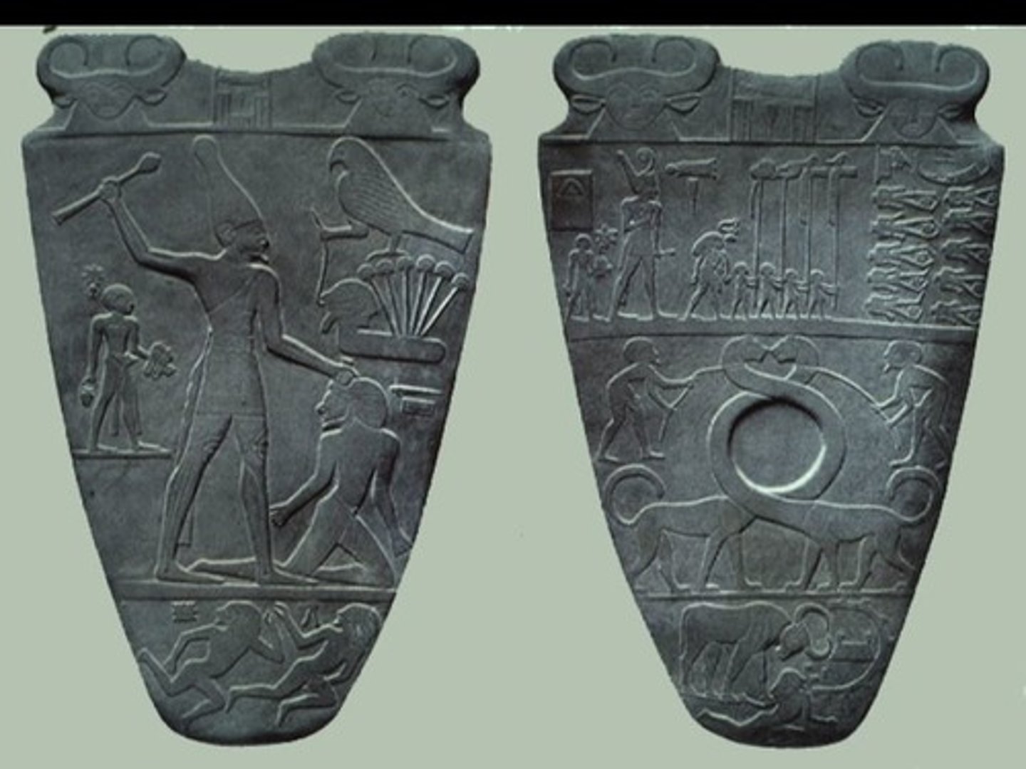 <p>This object depicts the unification of Upper and Lower Egypt into the "Kingdom of the Two Lands" under the divine king. This object is a ceremonial palette used in the ritual of mixing and applying the King's eye makeup.</p>