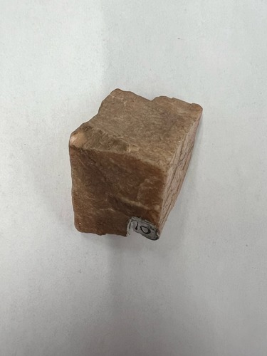 <ul><li><p>Pinkish orange</p></li><li><p>Non-metallic</p></li><li><p>Hardness: 6</p></li></ul>