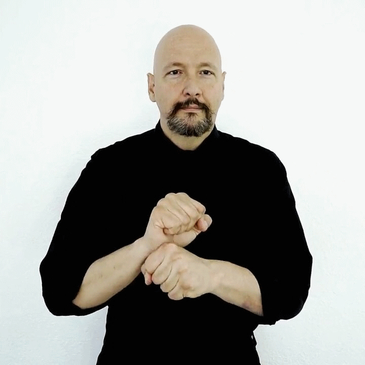 <p><span style="font-size: medium">shaping both hands into "fist shapes" (the letter "s.")&nbsp; With your palms facing downward, use your dominant fist to tap the wrist or the side of your non-dominant fist a few times.</span></p>