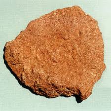 <ol><li><p>detrital/clastic</p></li><li><p>sand 1/16mm-2mm</p></li><li><p>Abundant feldspar, rock fragments and mineral grains</p></li></ol><p></p>