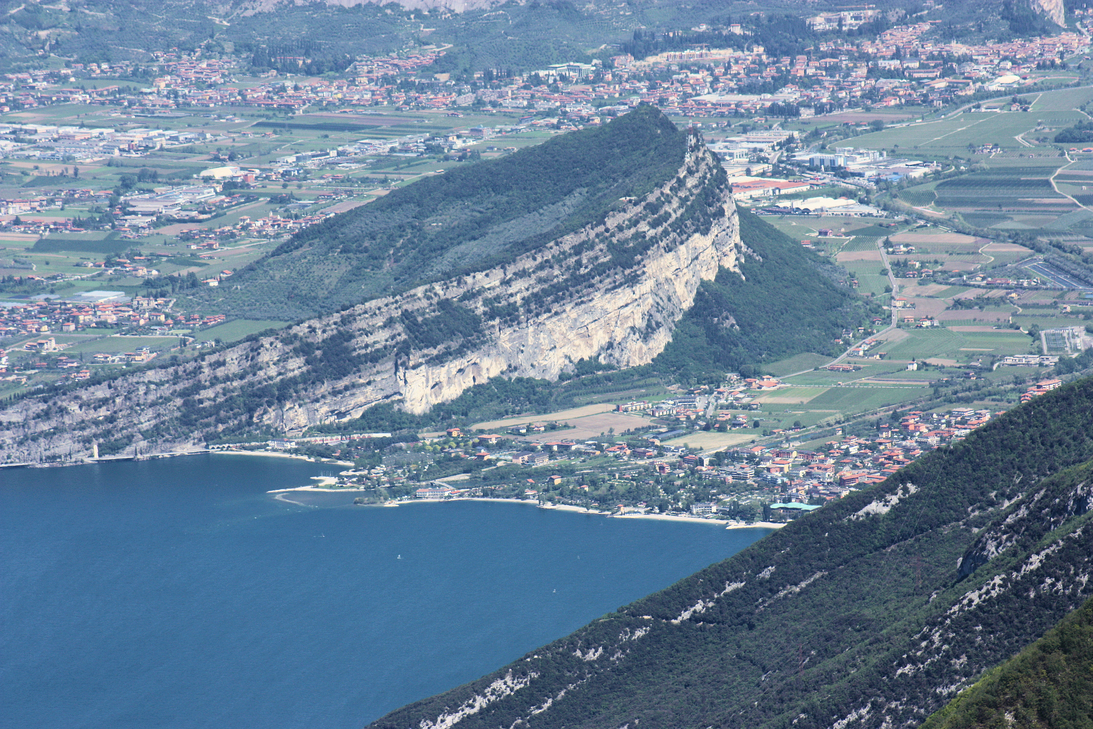 <p>gentle slope (dip slope) on one side that aligns with the dip of the cap rock, steep slope (escarpment) on the other side (exposed weaker rock) due to erosion</p>