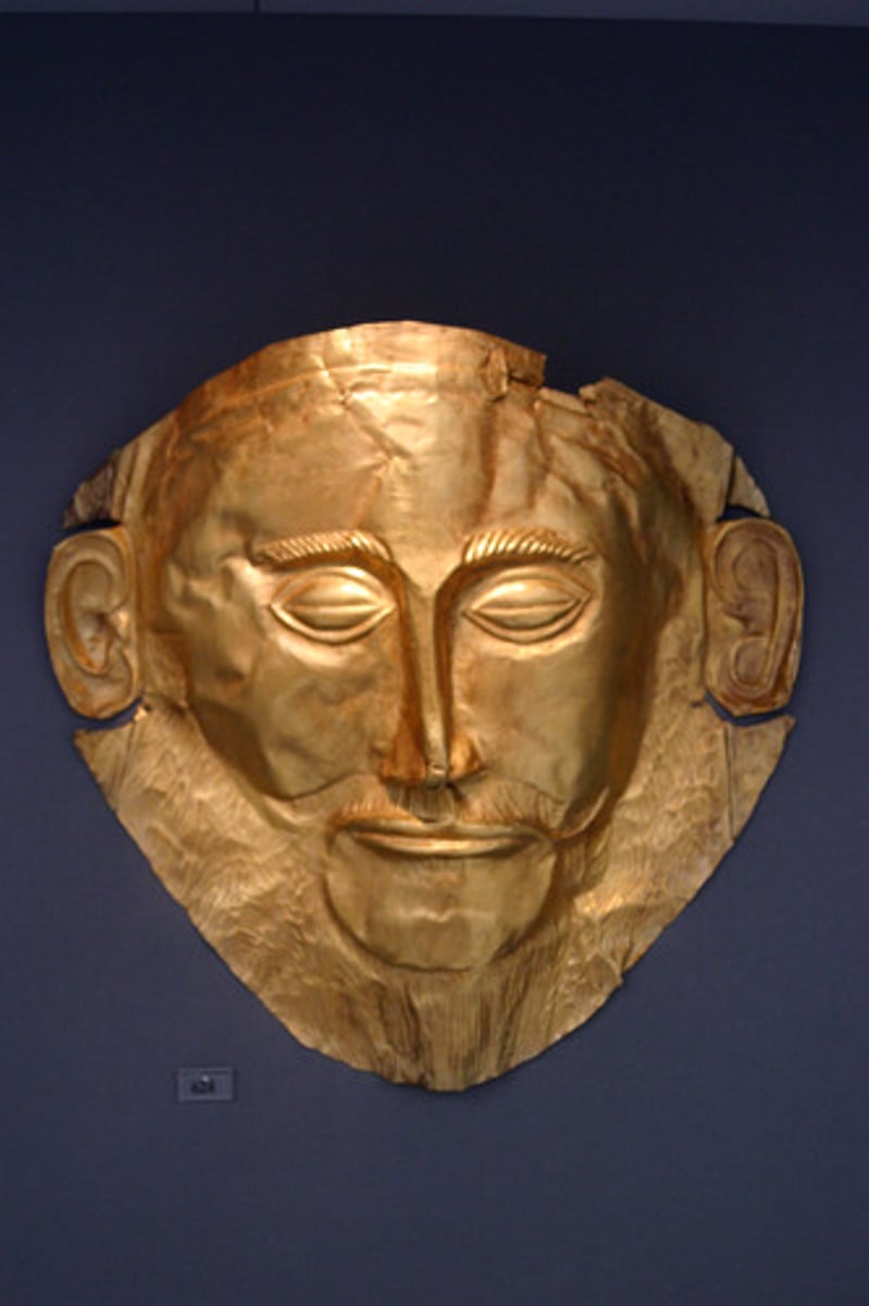<p>Who:</p><p>The mask was discovered by German archaeologist Heinrich Schliemann, who believed that he had found the body of the Mycenaean king Agamemnon1. However, modern archaeological research suggests that the mask predates the period of the legendary Trojan War by 300-400 years1.</p><p>What:</p><p>The Mask of Agamemnon is a gold funeral mask1. It was created from a single thick gold sheet, heated and hammered against a wooden background with the details chased on later with a sharp tool2.</p><p>Original Findspot:</p><p>Schliemann found the gold funeral mask in 1876, in a shaft tomb designated Grave V, at the site Grave Circle A, Mycenae1.</p><p>When:</p><p>The mask dates to about 1550-1500 BC1.</p><p>Why it's interesting and important:</p><p>The Mask of Agamemnon is one of the most distinctive archaeological objects and has been described as the "Mona Lisa of prehistory"1. It provides valuable insights into Mycenaean funerary practices and beliefs. Despite doubts about its authenticity and its association with Agamemnon, it remains an iconic symbol of Mycenaean culture3.</p>