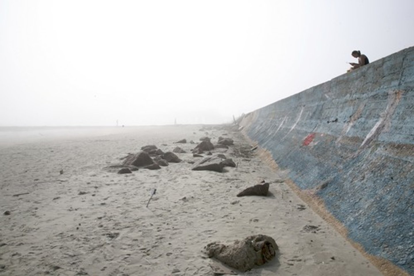 <p>A concrete wall which aims to prevent erosion of the coast by providing a barrier which reflects wave energy.</p>