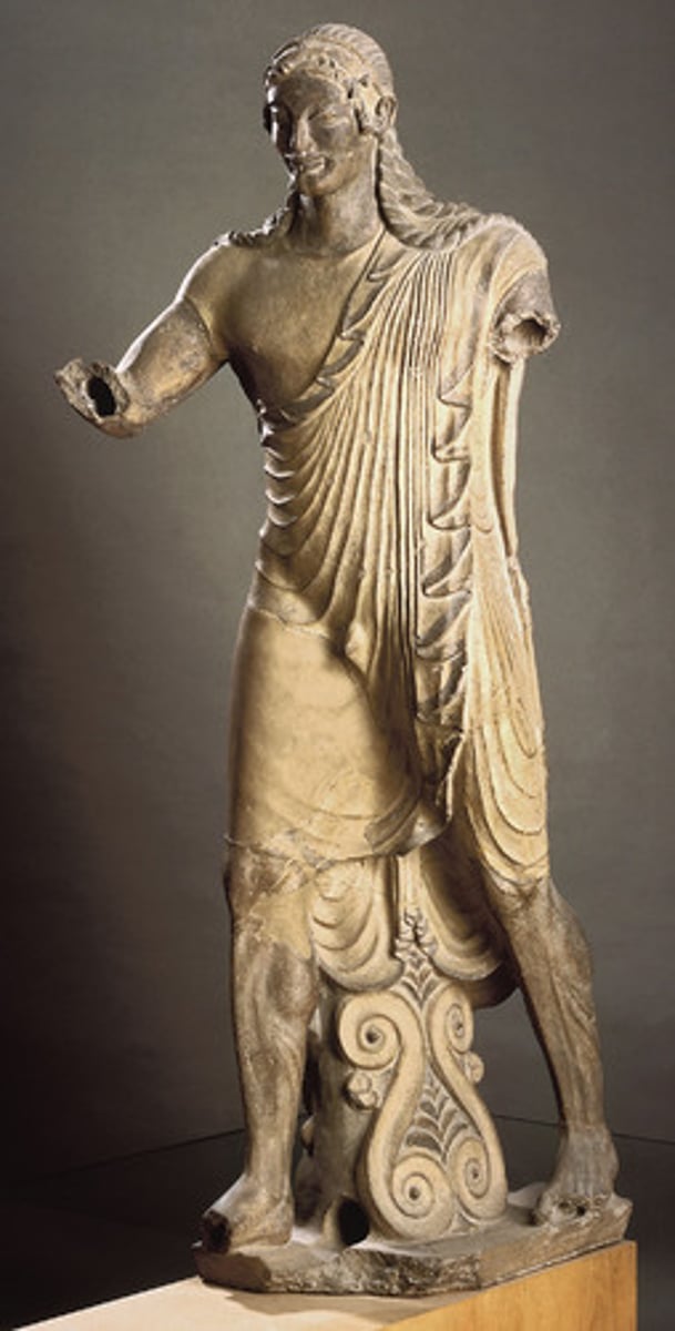 <p>Date: 510-500 BCE</p><p>Period/Style: Etruscan</p><p>Original Location: Veii, italy</p><p>Artist: Master sculptor Vulca</p><p>Material/Technique: terra cotta</p><p>Function: Depicts god Apulu (Apollo) which adorns the roof of the temple.</p><p>Context: Statues often adorned Etruscan roofs. The Greek archaic smile influenced the facial features of Apollo (which were inspired by Egyptian statuary).</p><p>Descriptive terms: sculpture in the round, archaic smile, Etruscan</p>