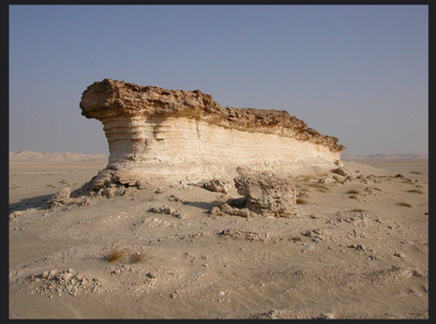 <p>Wind eroded rock structures consisting of horizontal layers of hard and soft rock</p>