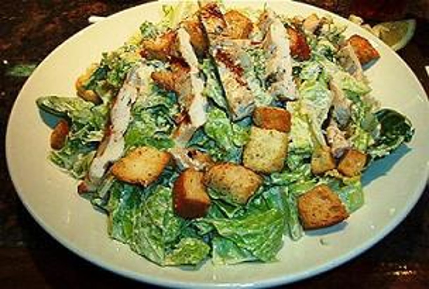 <p>romaine lettuce tossed with our made-in-house caesar dressing and 8 croutons then topped with 8 oz marinated and grilled chicken breast<br>caesar dressing &amp; parmesan cheese<br>frozen/chilled large bowl</p>