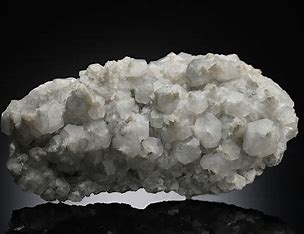 nonmetallic, white color, white streak, excellent cleavage in three directions not at 90 degrees