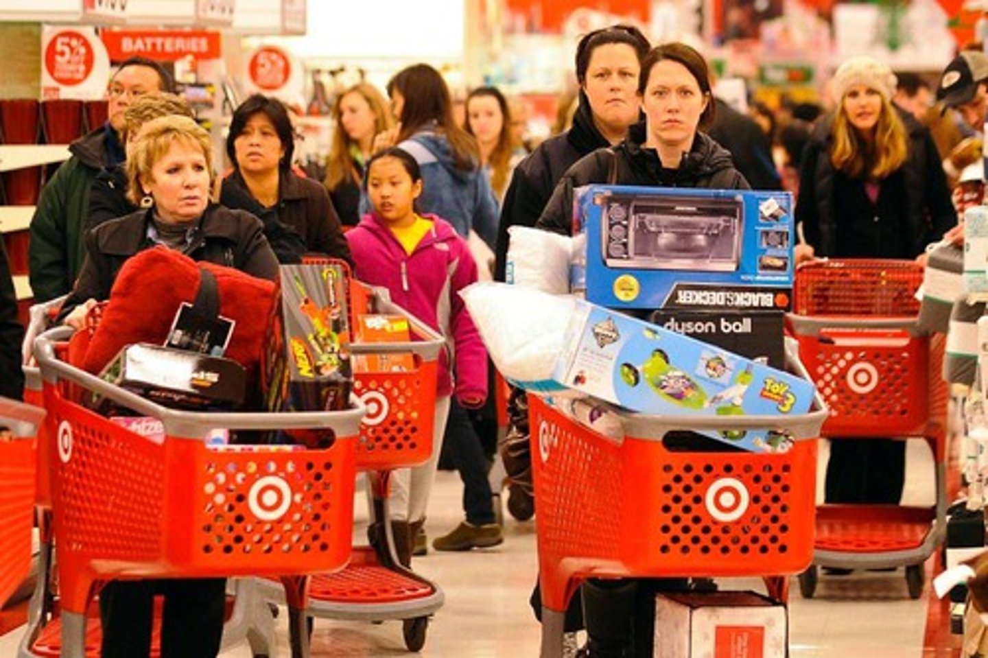 <p>the purchase of standardized products or services by large numbers of customers</p>