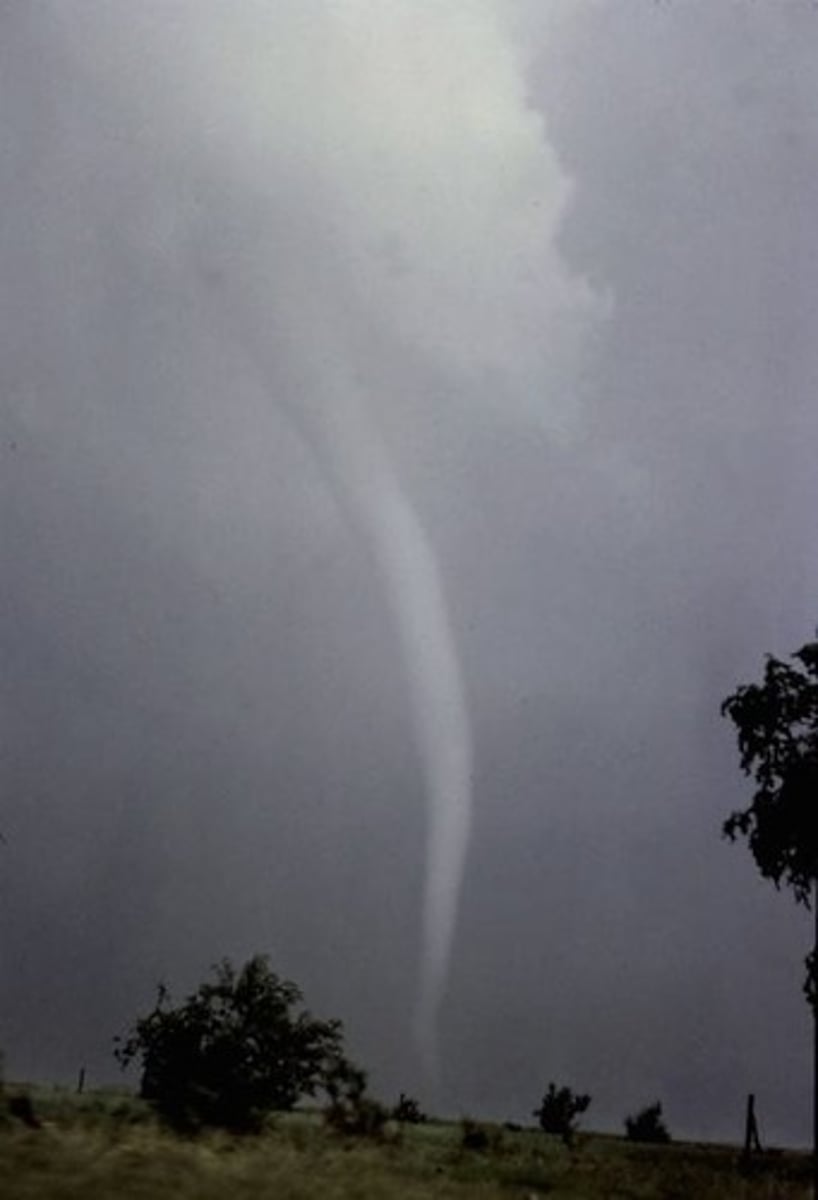 <p>Rapidly rotating column of air that blows around an intense area of low pressure.</p>
