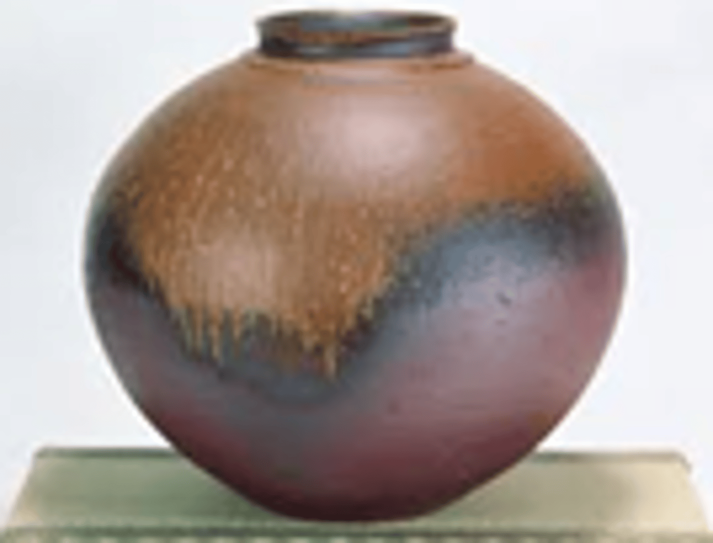 <p>Hard Japanese stoneware, <span class="bgY">brick red</span>, <span class="bgY">subject to irregular changes of color</span> resulting from alternating oxidation and reduction in the firing. Unglazed except for glaze formed by falling ash or by ash or straw packed around the pots in the kiln.</p>