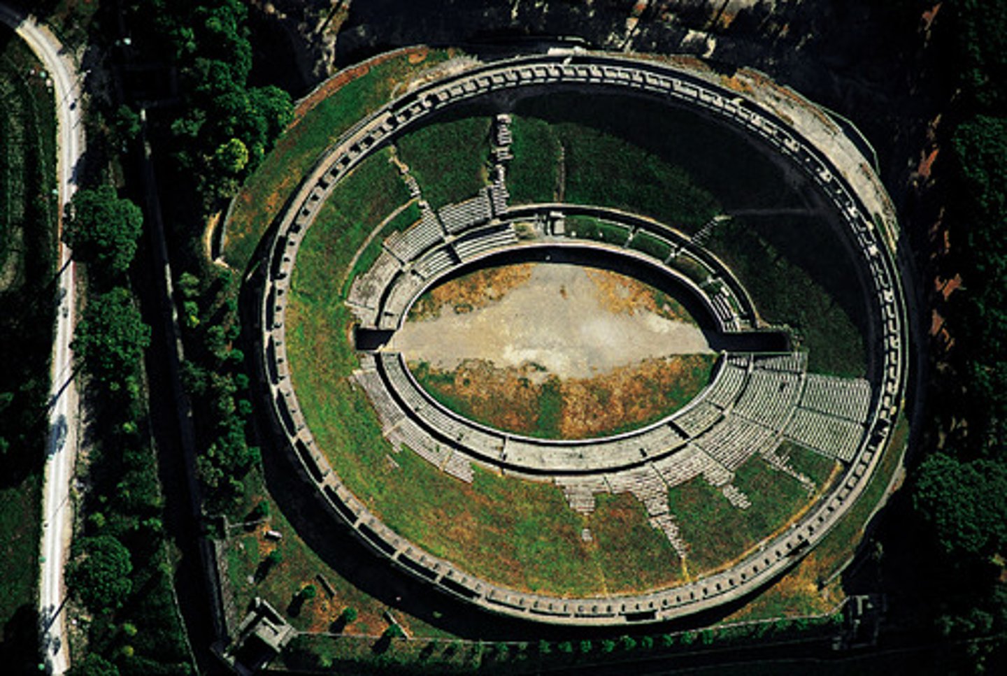 <p>an oval large stadium with tiers of seats</p>
