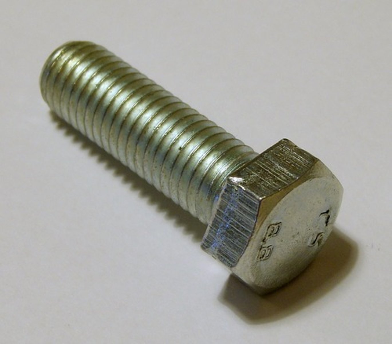 <p>fastening metal to metal with a wrench</p>