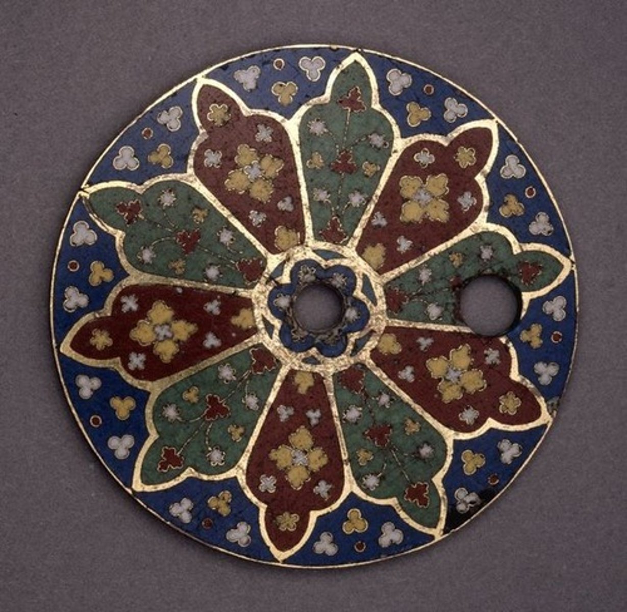 <p>involves fusing powdered glass to a surface by heating it to between 750 C and 850 C. When fired, the glass powder melts and turns into a smooth shiny coating.</p><p>It can be applied to gold, copper, silver, and aluminum.</p>