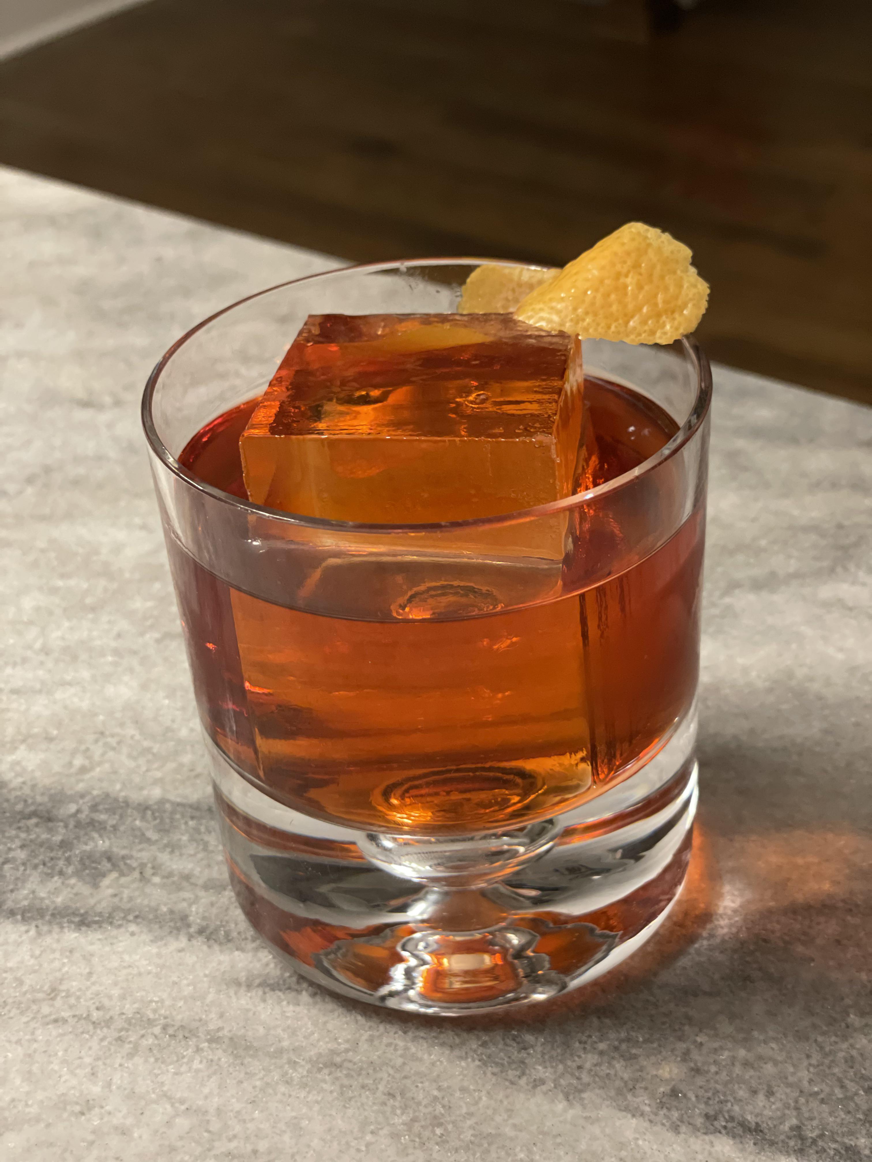 <p>negroni, 1 oz mezcal, 1 oz blanc vermouth, 1 oz Aperol, served on the rocks, garnished with orange peel</p>