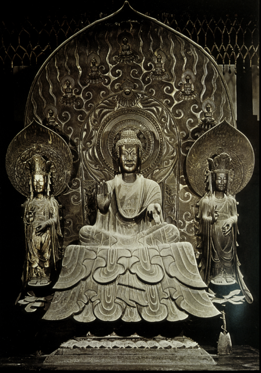 <p>Horyu-ji (main compound), Nara, c.711</p><ul><li><p>Pagoda on the left, lecture hall on the right</p></li><li><p>Pagoda has underground chamber: Set of sculptures, scenes of Buddha’s life (nirvana), also jade pieces found there</p></li><li><p>Not symmetrical from the spatial axis stemming from the entrance; indicates break from continental culture influence after Kofun period</p></li></ul><p></p><p>Horyu-ji Altar- Sakyamuni Triad </p><ul><li><p>Buddha sat with two Bodhisattvas at his side</p></li><li><p>32  marks on Buddha’s body;Ushisha, Urna, Snail-shell like curls of hair</p></li><li><p>Cast bronze technology</p></li><li><p>Inscription is about recovery for Prince’s recovery from Empress Suiko</p></li><li><p>Bodhisattvas aren’t noticeably identifiable so it shows early understanding of Buddhism teachings</p></li><li><p>Compared with Buddha in Longmen, Northern Wei Dynasty because of similar mandola and draped fabric</p></li><li><p>Norther Wei Buddha Triad piece has chinese garments (knot) appealing to cultural norms</p></li></ul><p></p>