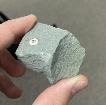 <p>Smoothish, black on bottom, <strong>Sedimentary,</strong> Lightest solid gray rock</p>