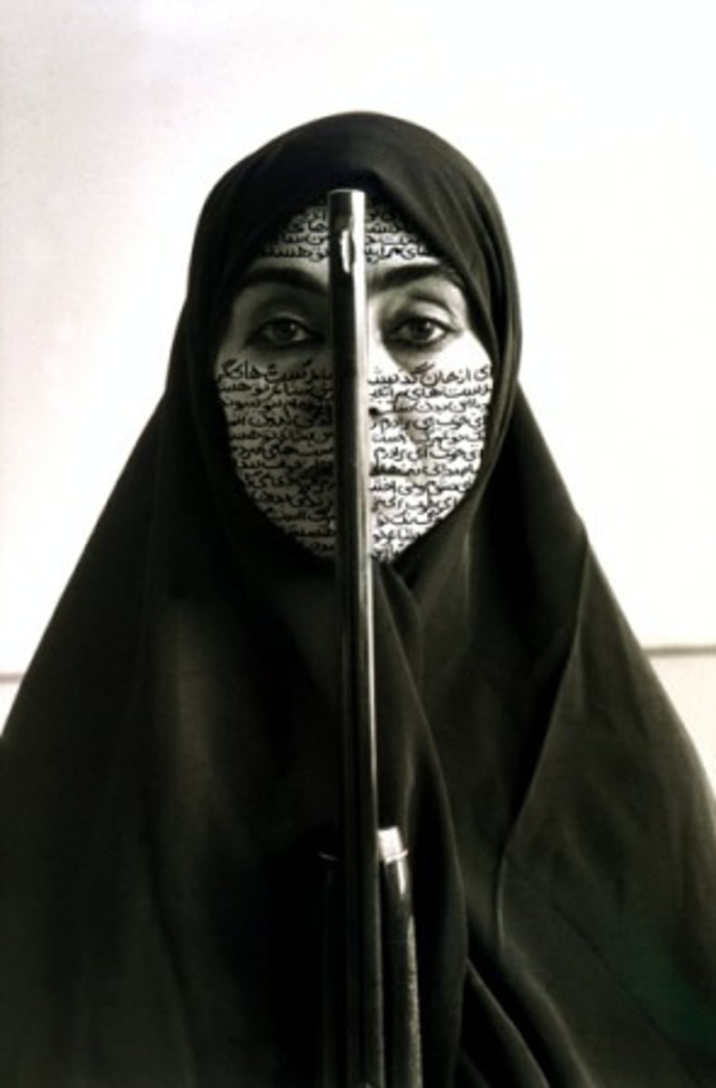 <p>Women of Allah series</p><p>Artist = Shirin Neshat</p><p>Photographer = Cynthia Preston</p><p>1994 CE</p><p>Form: Ink on Photograph</p><p>Function: Some people view it as a commentary on female oppression, while others may see it as a strong woman defending her faith.</p><p>Nishat's featured wearing a chador, or a large piece of cloth that covers the head and upper body, leaving the face exposed, worn by many Muslim women. Nishat used ink to write across her face in the photo. It is a text of a poem written in Farsi that questions a woman's role in society and in revolution. The barrel of a rifle divides her face, casting a shadow that darkens one half of her face. An interpretation of "Rebellious Silence" may vary depending on your personal belief system. Some may view it as a commentary on female oppression. While others may see it as a strong woman defending her faith.</p>