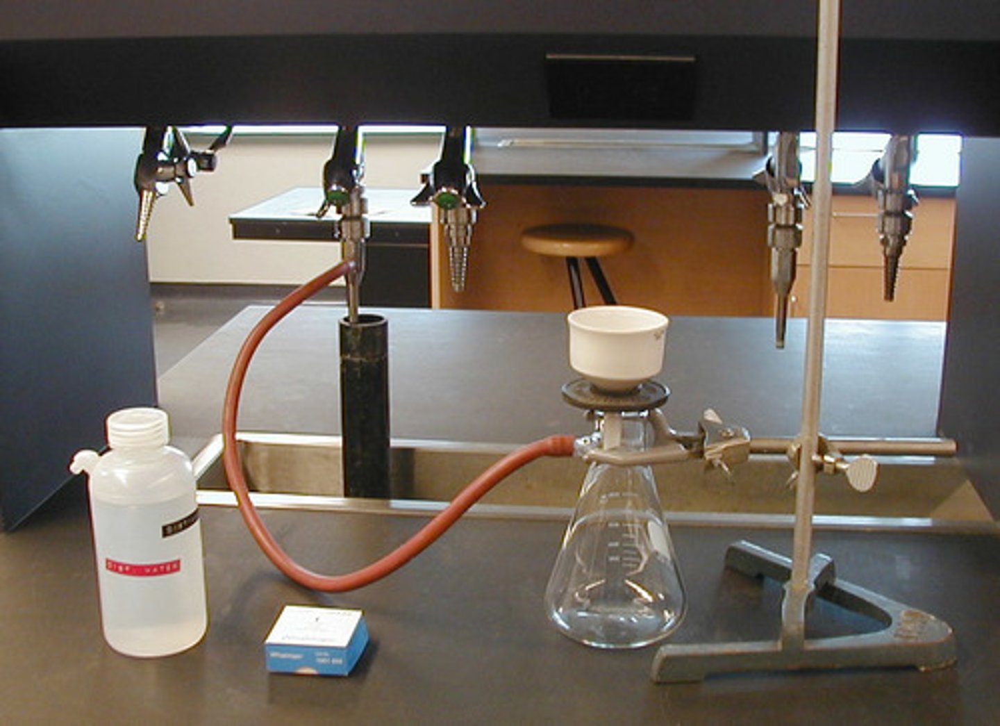 <p>process of isolating pure solid from liquid (filtrate) using vacuum</p>