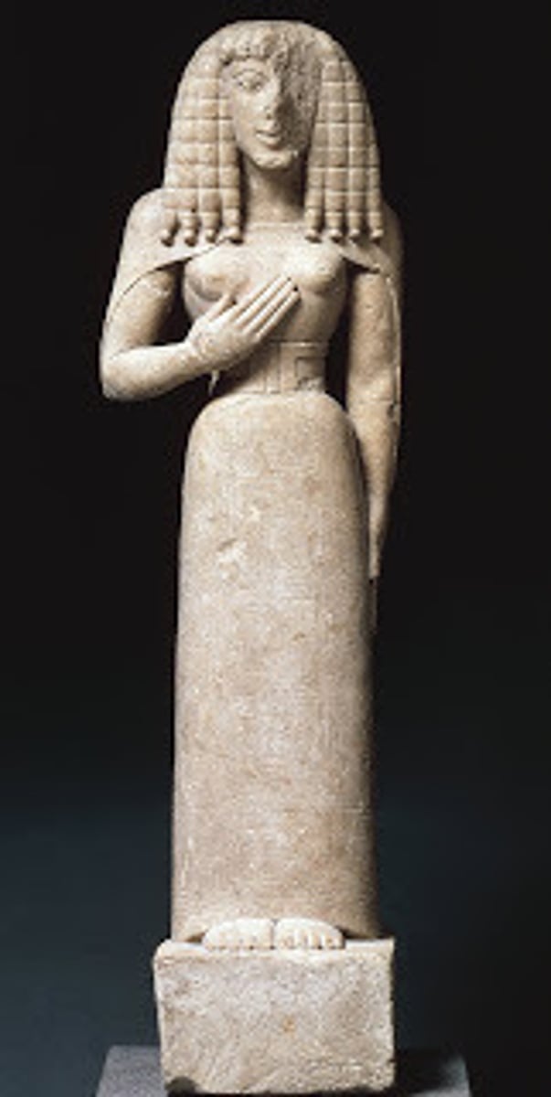 <p>Who: The Auxerre Kore was created by an unknown ancient Greek artist1.</p><p>What: The Auxerre Kore is a small (75 cm high) limestone Cretan sculpture1. It is a Kore ("maiden"), perhaps a votary rather than the maiden Goddess Persephone herself1.</p><p>Where: Probably from crete The Kore was found in a vault in the Museum of Auxerre in France1. It is currently housed in the Louvre Museum in Paris1.</p><p>When: The Kore dates back to around 650 - 625 BCE1.</p><p>Why it's interesting and important: The Auxerre Kore is significant for several reasons:</p><p>It is one of the earliest known Greek sculptures1.</p><p>The Kore still has the narrow waist of a Minoan-Mycenaean goddess, and her stiff hair suggests Egyptian influence1.</p><p>The early Archaic style of the Kore has been fancifully termed "Daedalic"1.</p><p>Its mysterious arrival at a provincial French museum gave it a journalistic allure1.</p><p>Excavations in the 1990s by Nikolaos Stampolidis at Eleutherna in Crete have helped establish more precisely a date and place of origin for the Dame d'Auxerre, in the region of Eleutherna and Gortyn, with the recovery from gravesites of very similar carved ivory faces and phallic symbols1.</p>