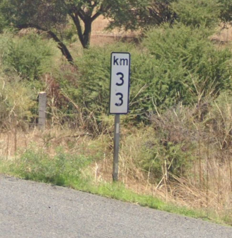 <p>Kilometre markers— black rimmed, mounted at hip height, with KM at the top and the kilometres arranged vertically</p>
