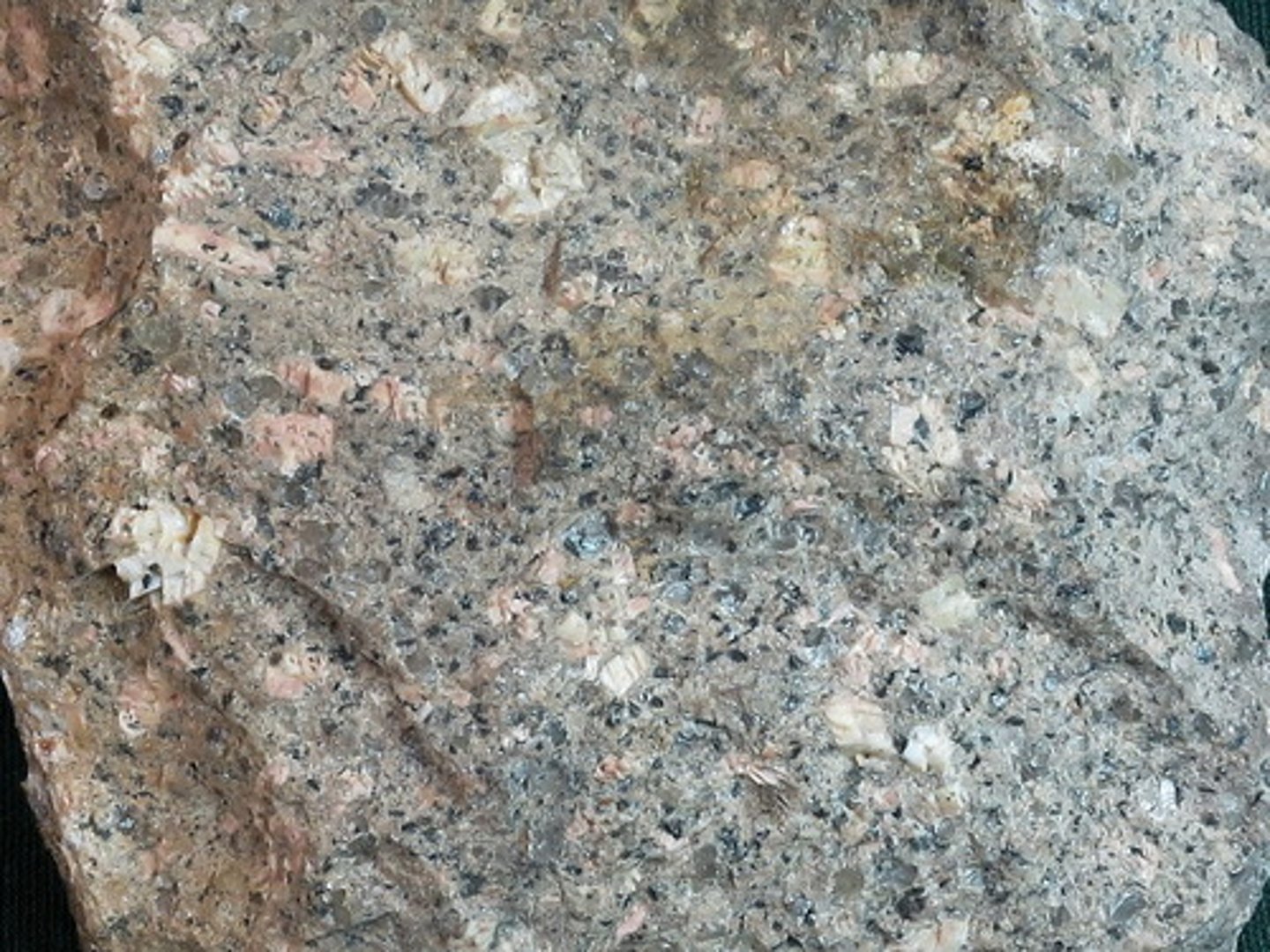 <p>This rock has loads of pink orthoclase and white albite phenocrysts, and many smaller ones of quartz. The matrix is very fine-grained and light-gray, making up only about 40% of the rock. (volcanic rock - quickly-cooled, fine-grained or glassy)</p>