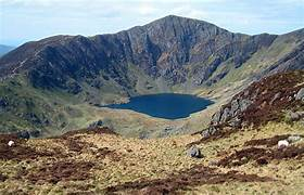 <p>a bowl shaped hollow with a steep backwall and a tarn </p>