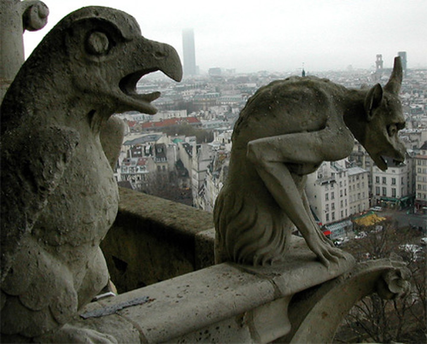 <p>waterspout carved in grotesque figures on a building</p>