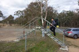 <p>a pair of ladders that enable people to cross over a fence</p>