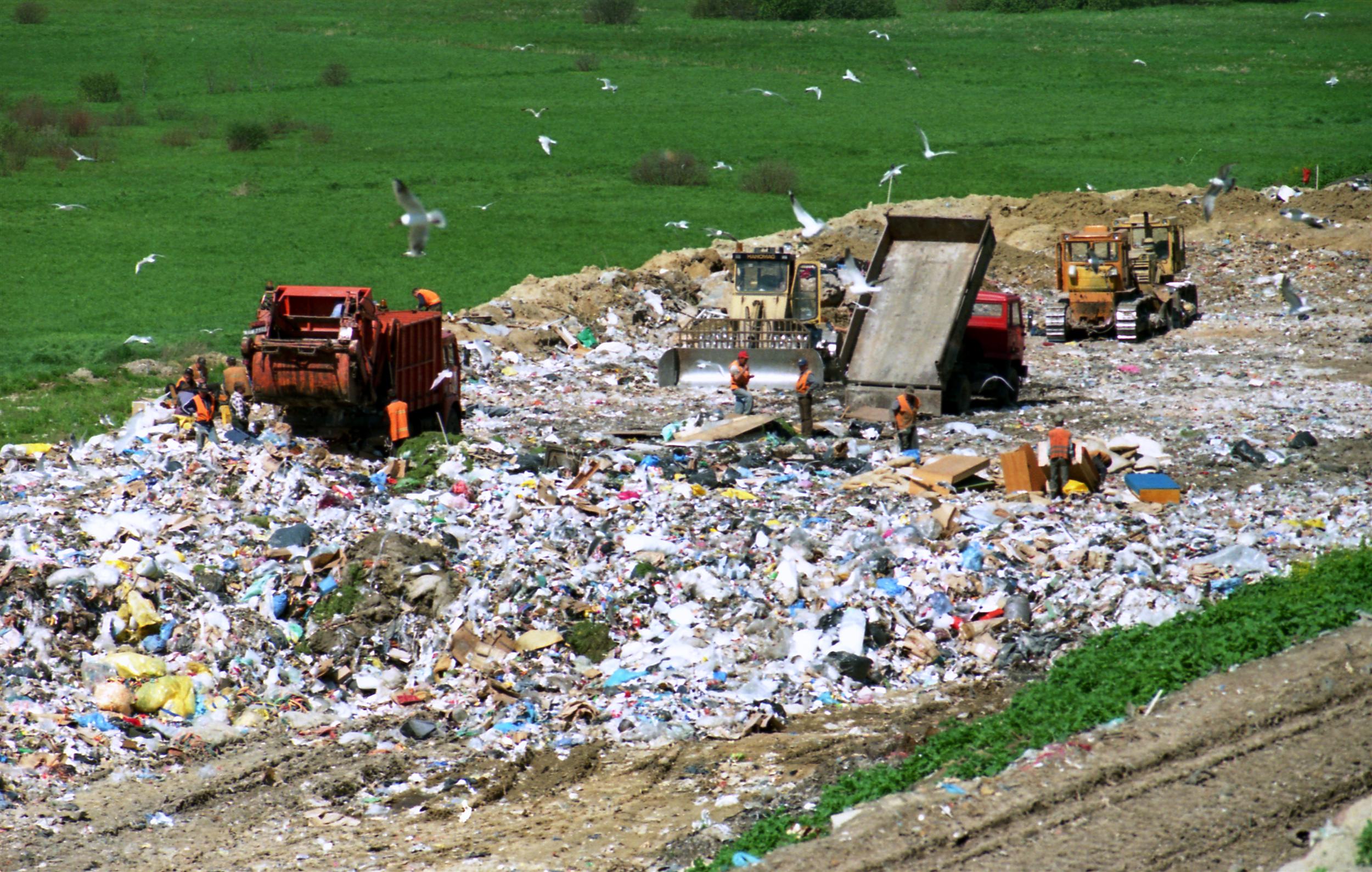 <p>a place where waste material is buried and then covered with soil</p>