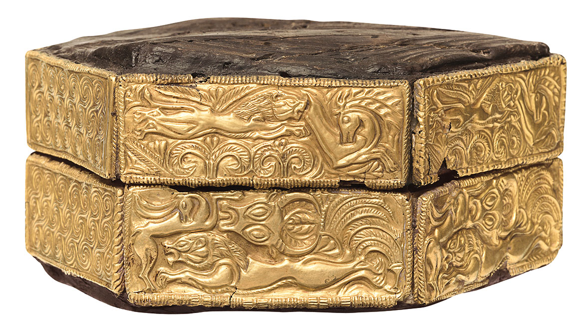 <p><strong><u>Date</u></strong> : 16th century</p><p></p><p><strong><u>Location</u></strong> : Shaft Grave V, Grave Circle A, Mycenae</p><p></p><p><strong><u>Function</u></strong> : <strong>jewellery box</strong></p><p></p><p><strong><u>Material</u></strong> : wood and gold</p><p></p><p><strong><u>What is pictured</u></strong> :</p><ul><li><p>lion chasing horses</p></li><li><p>heads of cattle</p></li><li><p>swirls/spirals</p></li></ul><p></p><p><strong><u>Significance</u></strong> :</p><ul><li><p>evidence of craftsmanship ( <strong>repousse, filigree</strong> ) - attaching small golden plates to a wooden box.</p></li><li><p><strong>rare wooden object</strong> - wood usually does not last this long and will rot.</p></li><li><p>Evidence for <strong>burial customs</strong> perhaps - <strong>gifts</strong> ?</p></li></ul><p></p>