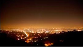brightening of the night sky caused by street lights and other man-made sources, which has a disruptive effect on natural cycles and inhibits the observation of stars and planets.