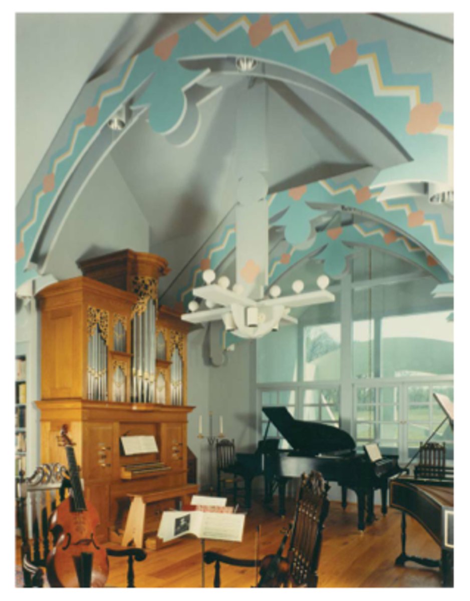 <p>a sculpture made of several different items that dangle from a ceiling and can be set into motion by air currents</p>
