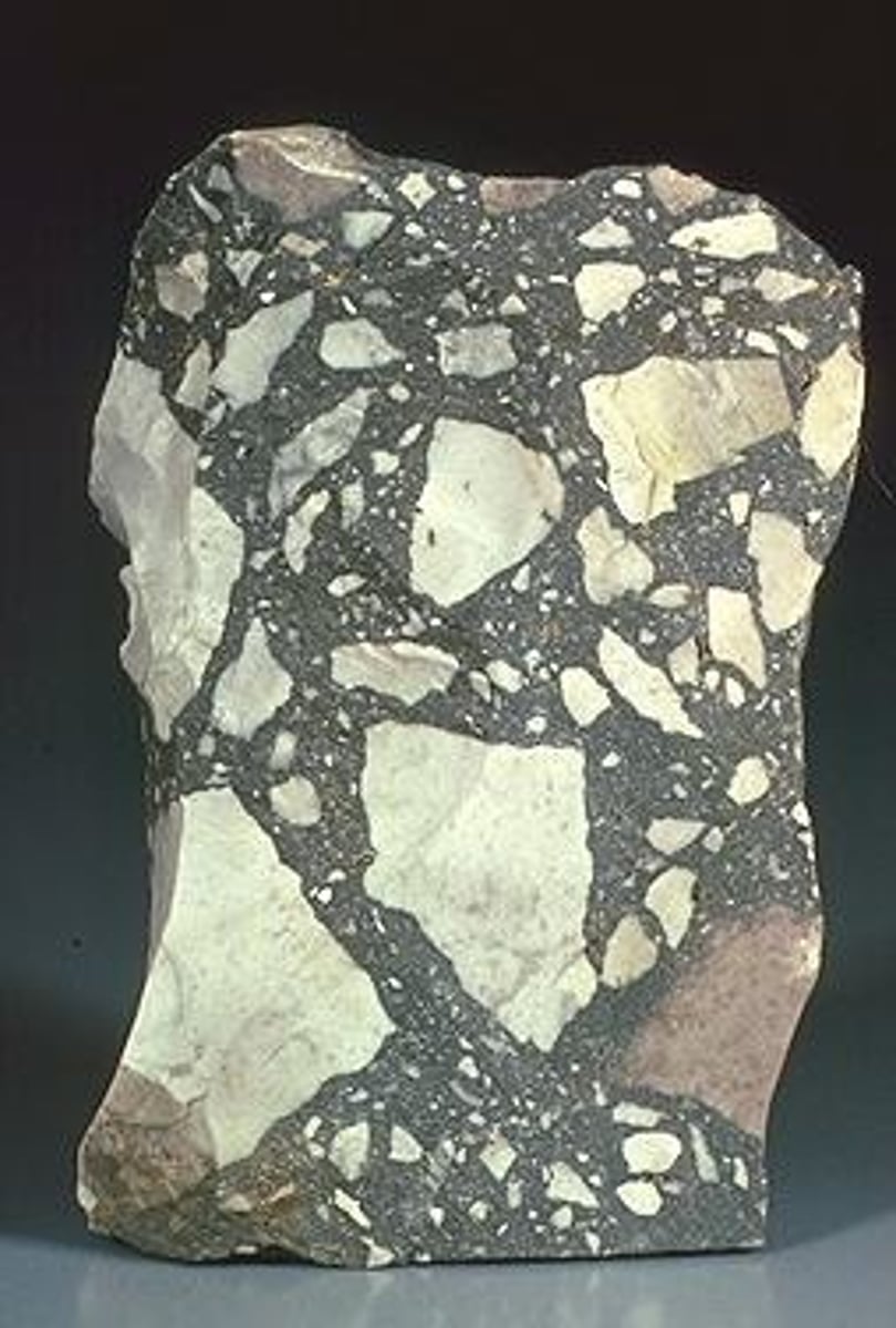 <p>Sedimentary rock<br>Texture: Coarse Grained. (gravel size)<br><br>consisting of angular fragments; or rock broken into angular fragments by faulting</p>