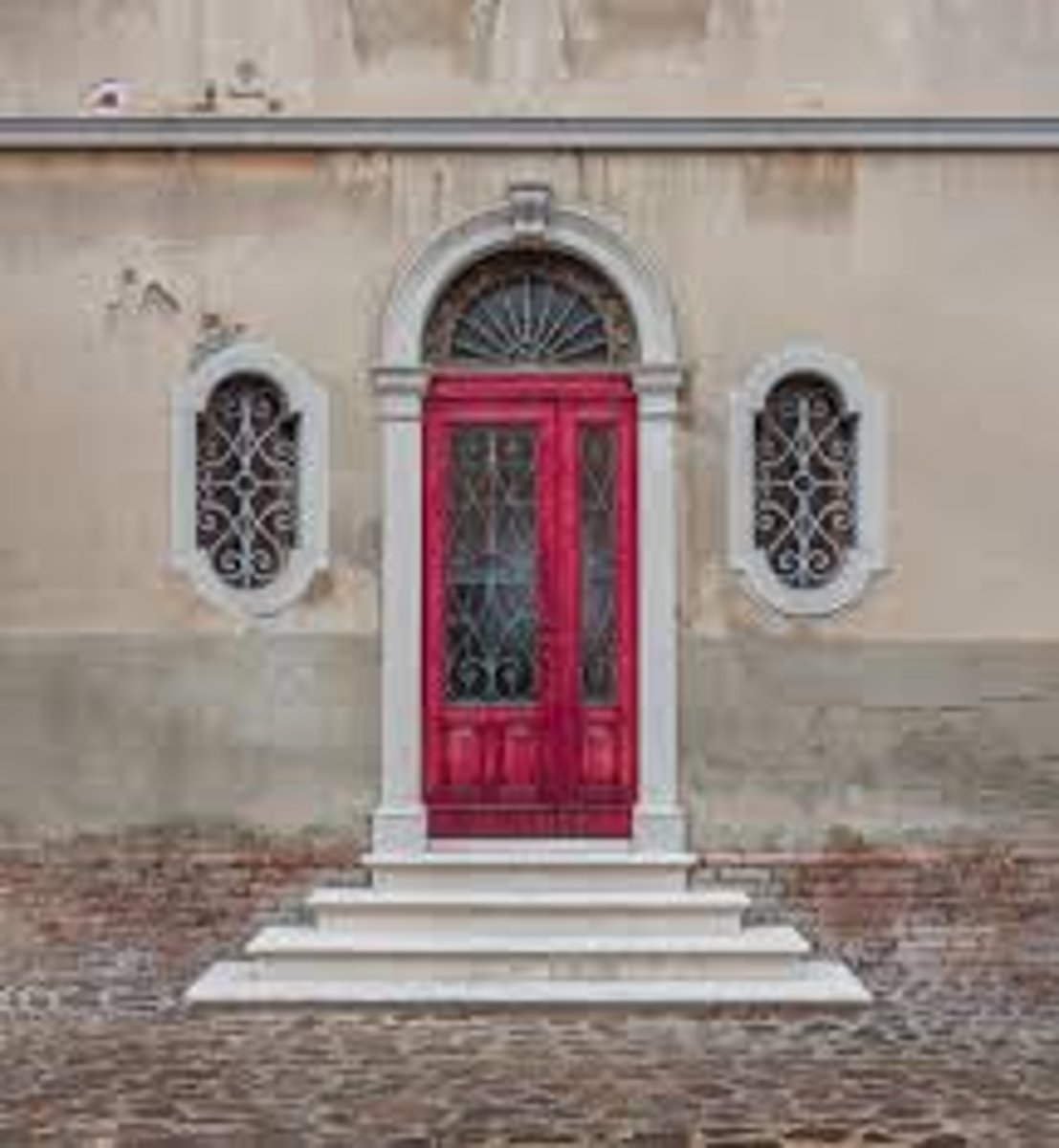 <p>A door opening, with a semicircular window (fanlight) above and flanked by vertical windows (sidelights)</p><p>Similar to a Palladian Window</p>