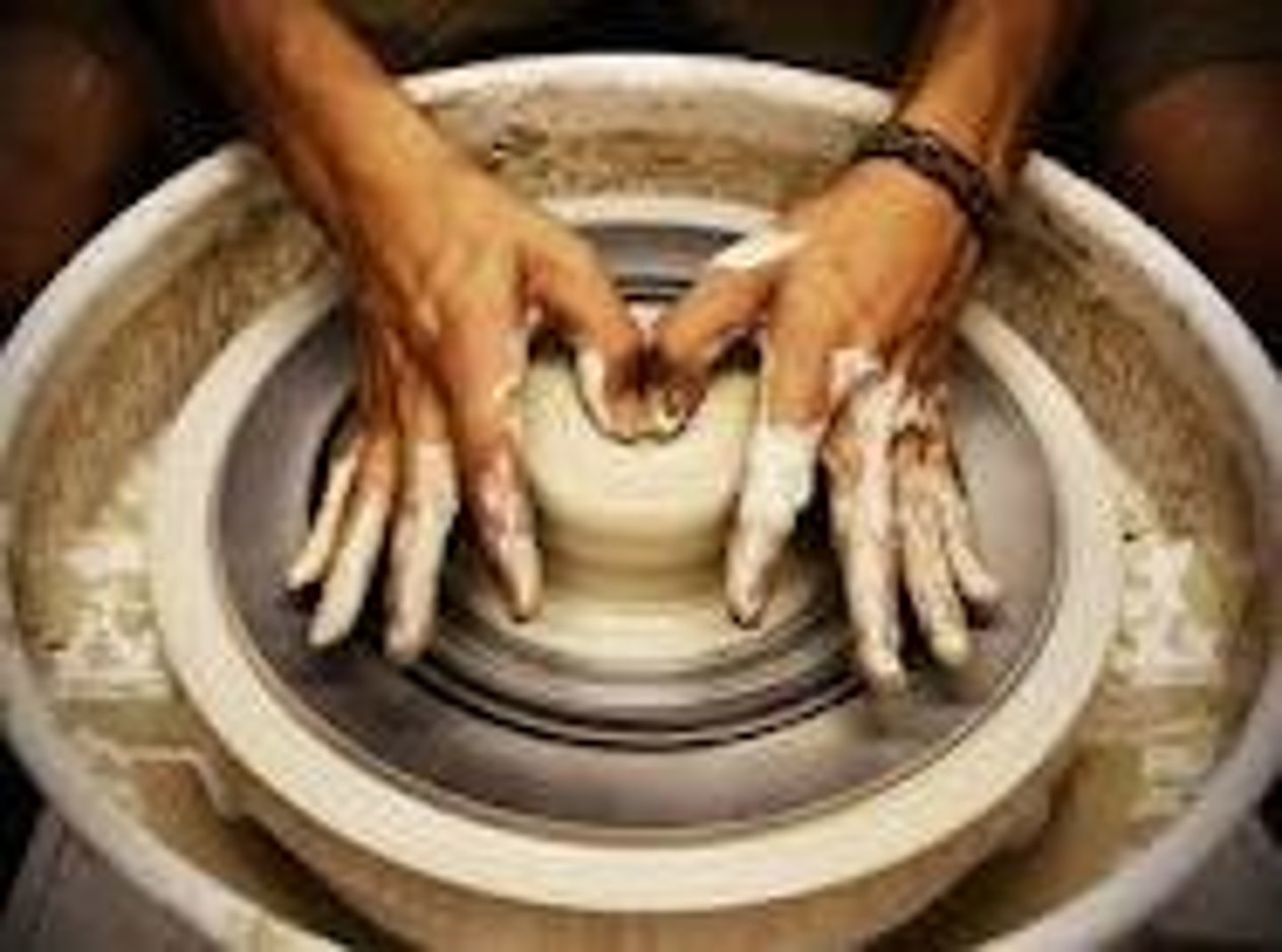 <p>molding clay forms on a potter's wheel</p>