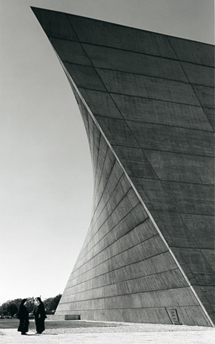 <p>having opposite curvatures at a given point</p>