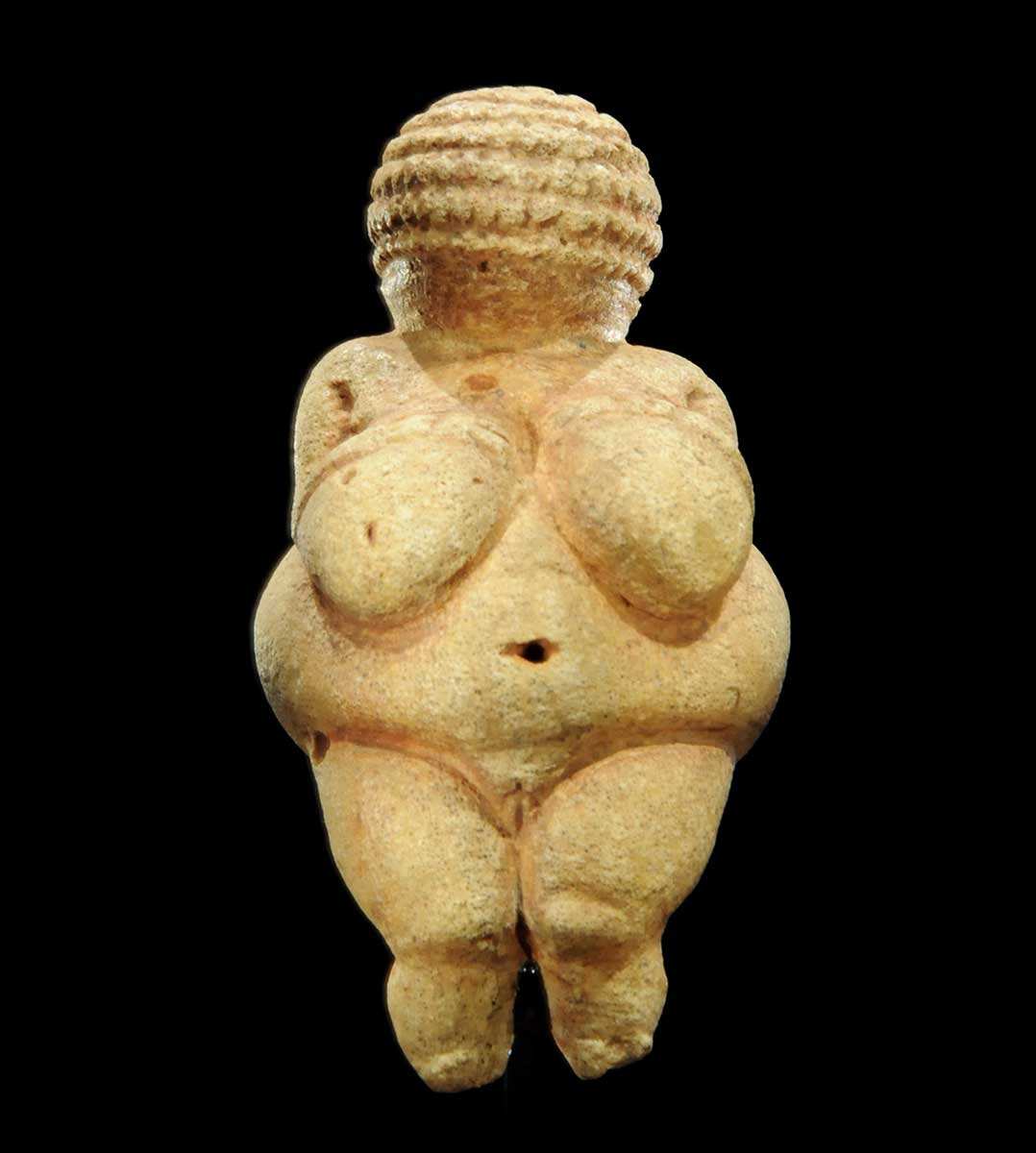 <p></p><ul><li><p>Description: Small limestone figurine of a female with exaggerated features</p></li><li><p>Size: Approximately 4.4 inches tall</p></li><li><p>Features: Large breasts, rounded belly, wide hips, no facial features</p></li></ul>