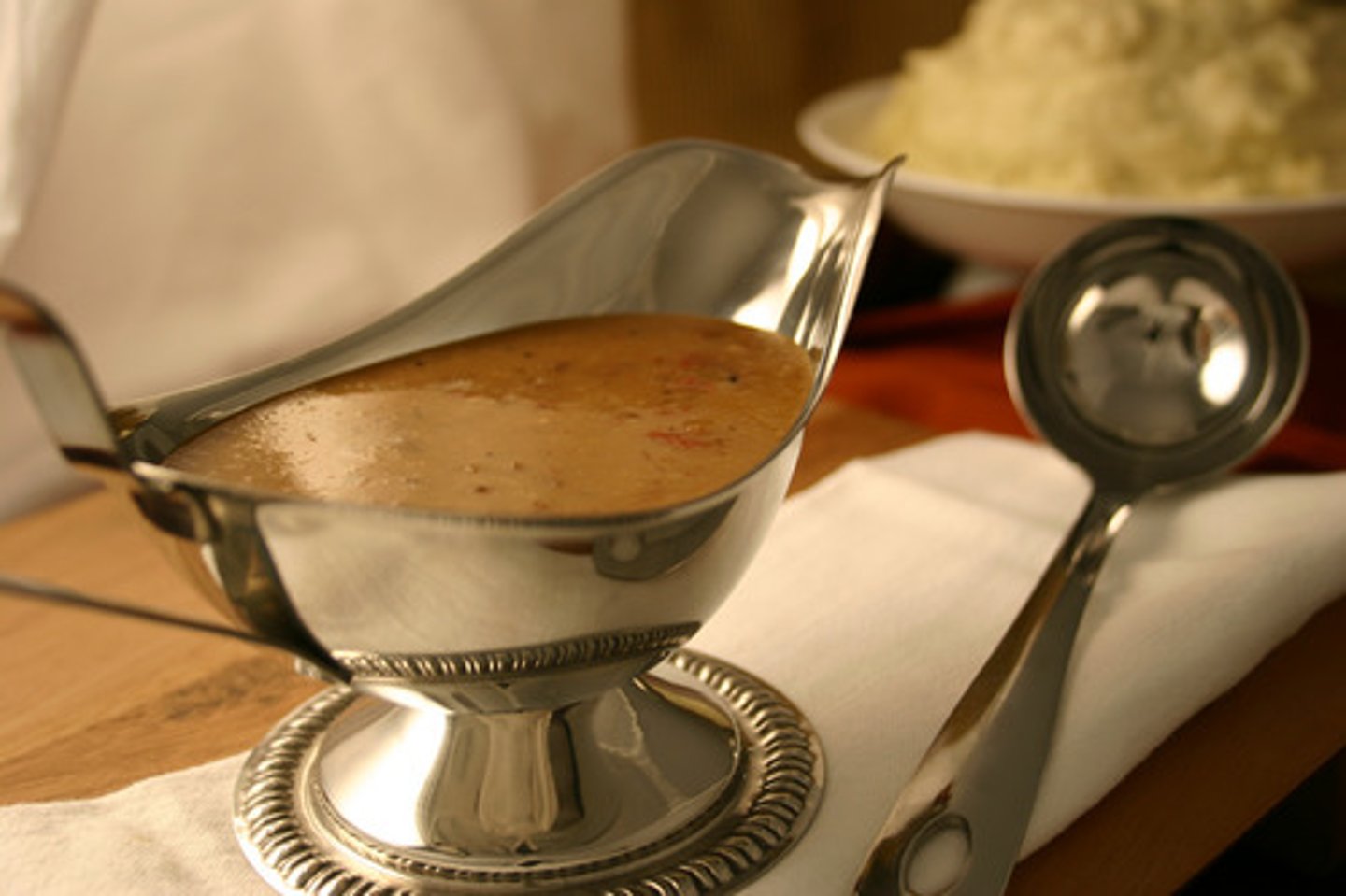 <p>A sauce made from meat juices, often served with roast meat.</p><p>• Collocations: thick gravy</p><p>• IELTS EX: In the UK, sausages are often eaten with mashed potatoes and gravy.</p>