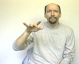 <p>Hold your left hand palm face down and wiggle your fingers as you <strong>move your arm to the left</strong></p>
