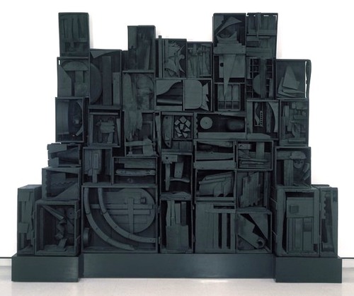 A Russian/American sculptor who likes to use: 
wood found objects and a monochromatic color theme to create abstract art to express personal memories.