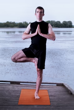 <p>Known as Vrksasana. It is a basic yoga pose where the hands are raised upward in prayer position. Then, the sole of the right foot is positioned on the left thigh.</p>