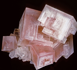 <ul><li><p>NaCl</p></li><li><p>Face-centered cubic unit cell</p></li><li><p>Isometric</p></li><li><p>Perfect cleavage in 3 directions {100}, {010}, {001}</p></li><li><p>Very soluble in water</p></li><li><p>Tastes salty</p></li><li><p>Typically forms cubic crystals when euhedral</p></li><li><p>Sometimes “hoppered”</p></li><li><p>Moh’s 2.5</p></li><li><p>Generally colourless to white (Can even be blue, or coloured by impurities (yellow, grey, etc))</p></li></ul><p></p>