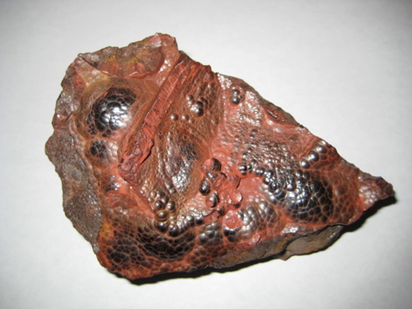 <p>Metallic mineral; steel gray (metallic) to dark red/brown (earthy), hardness 6(metallic) and 1.5(earthy), red brown streak</p>