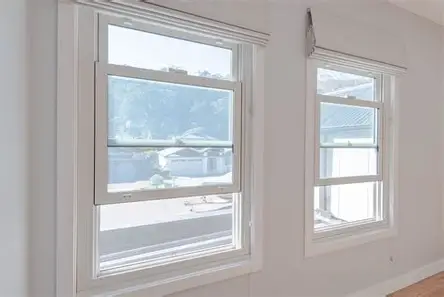 <p>a window that has two vertically hung sashes, each in separate tracks</p>