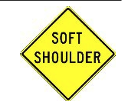 <p>What does a Soft Shoulder Ahead sign warn of?</p>