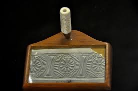 <p>a small cylindrical stone decorated with incised patterns. When rolled across soft clay or wax, a raised pattern or design (relief) is made, which served in Mesopotamia and Indus Valley cultures as an identifying signature</p>