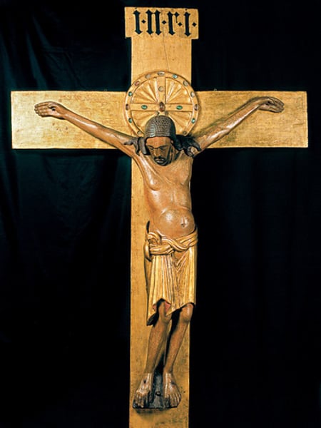 <p>Cologne Cathedral, Germany c. 970; Painted and gilded wood; Medieval art; expressive style; pained expression, sagging body, tilted legs, stretched skin; pose suggests suffering of christ; crucifix didn't emerge in 300s and 400s because of the stigma of crucifixion seen as a punishment; in 600s, this method of punishment was discontinued so crucifixion was represented in art as a symbol</p>